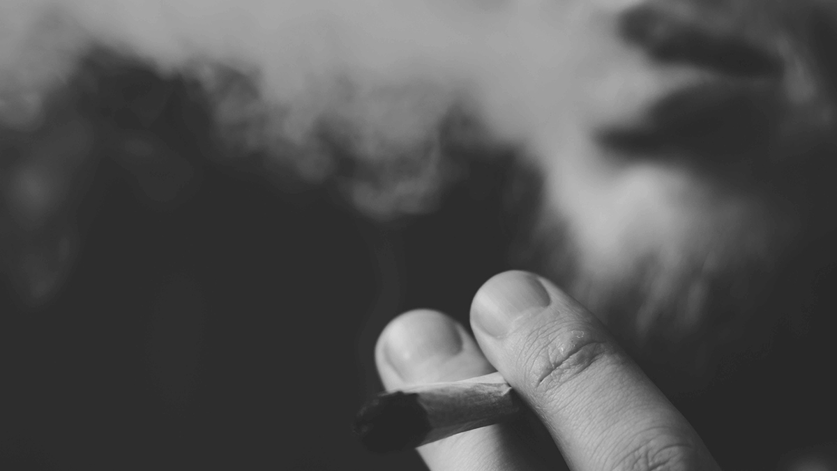 Image of Fingers Holding Smoking Weed