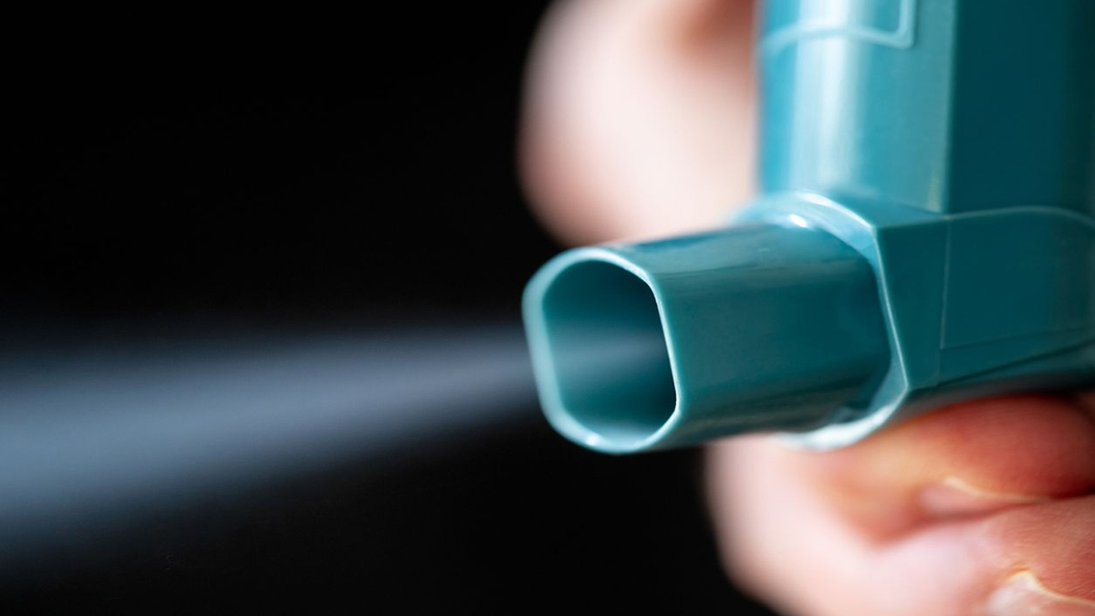 Image of a Hand Holding a Inhaler Focused