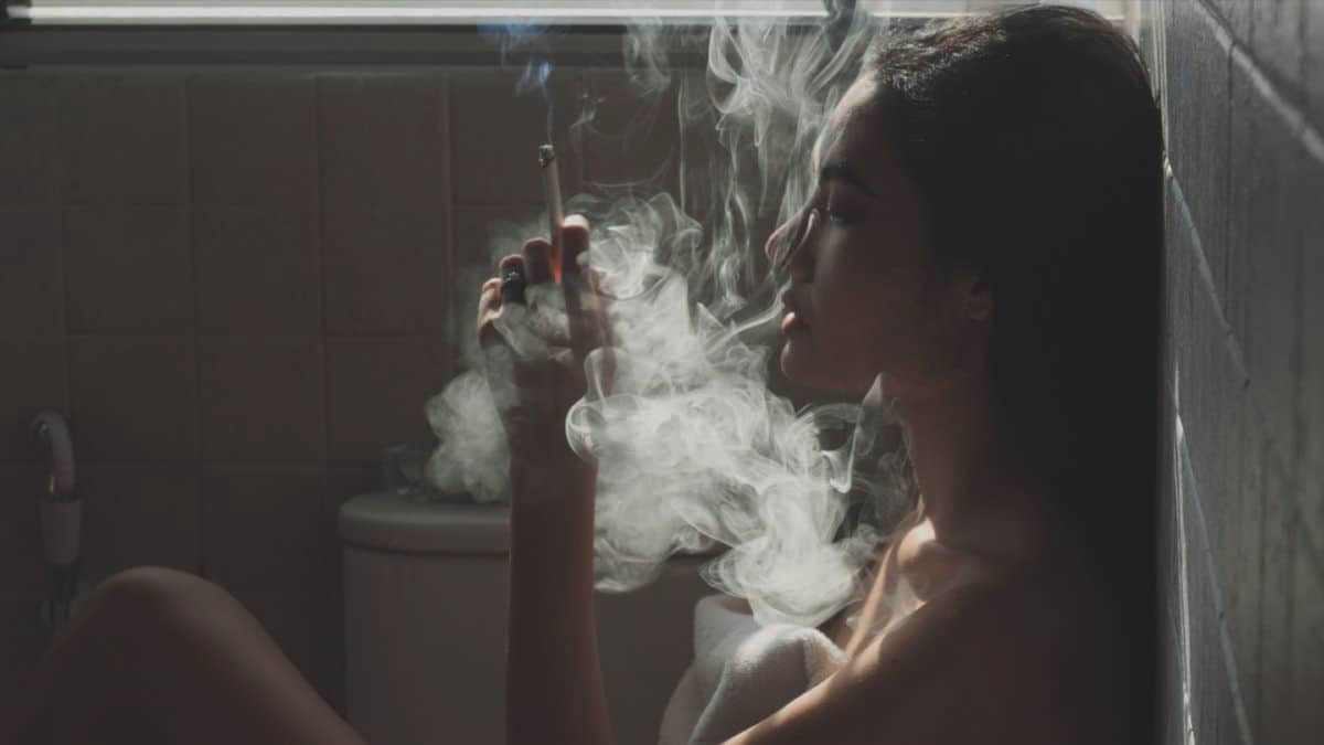 Image of a woman smoking weed in the bathroom