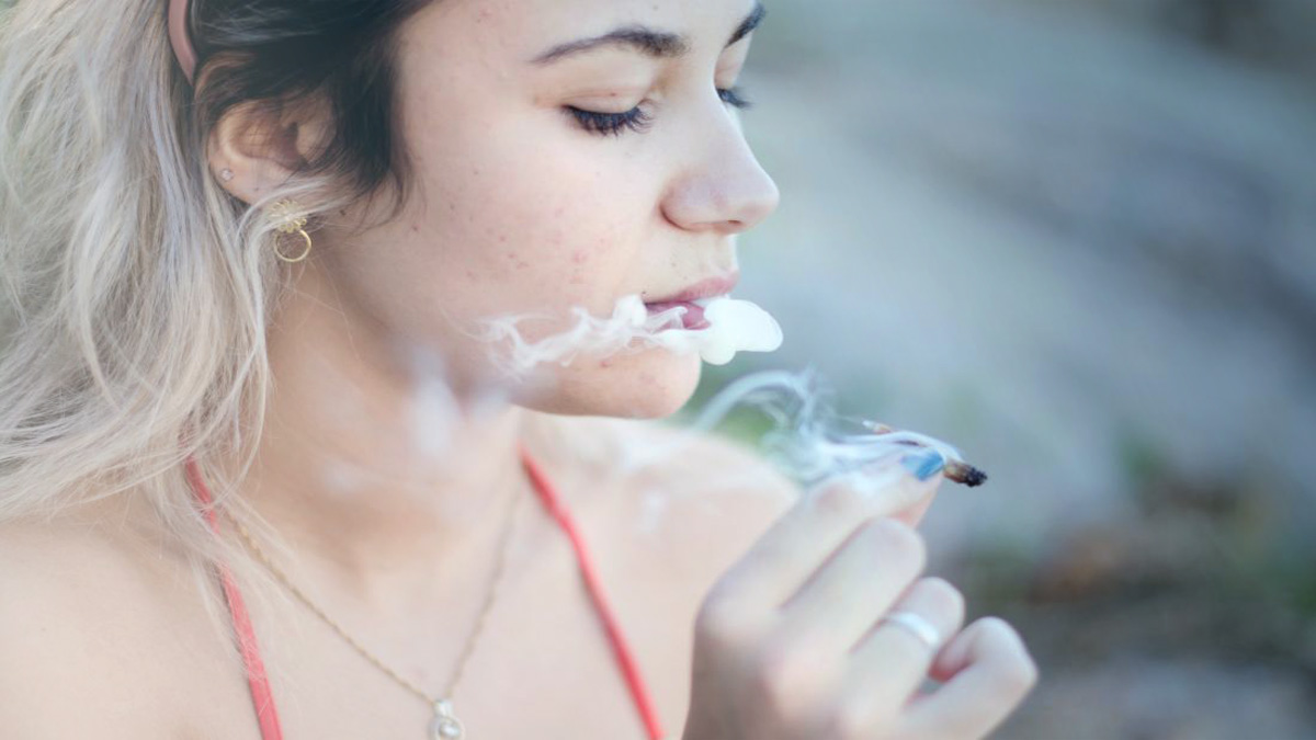 A woman smoking a blunt