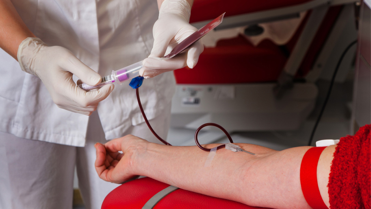 Patient with a nurse getting blood plasma for donation