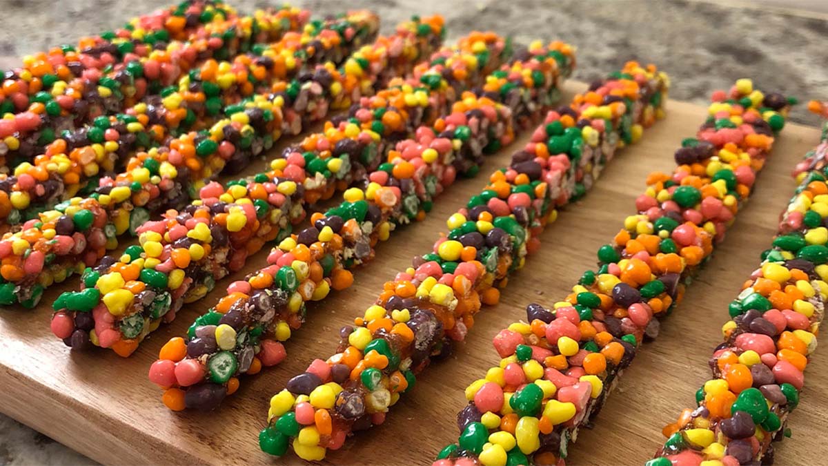 Colorful THC nerd ropes arranged on a wooden board