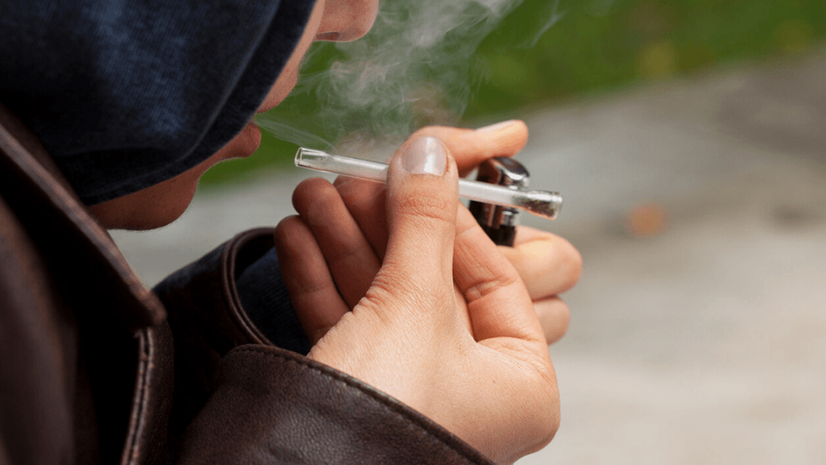 Image of a person smoking a one hitter