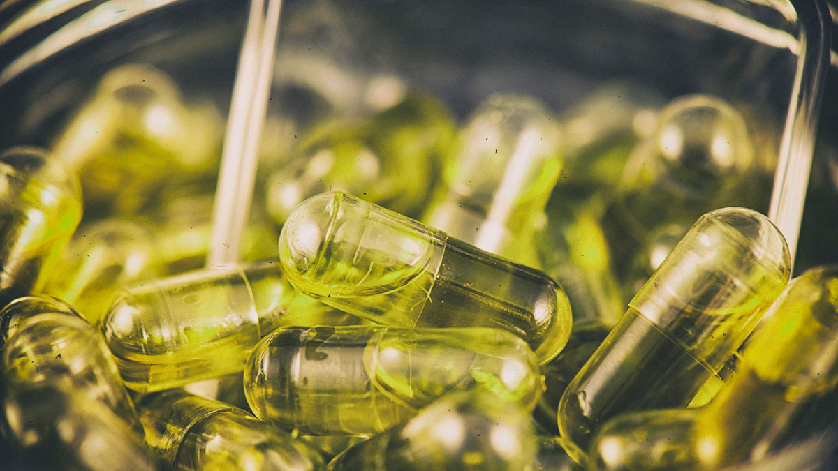 Cannabis capsules infused with cbd oil in a jar