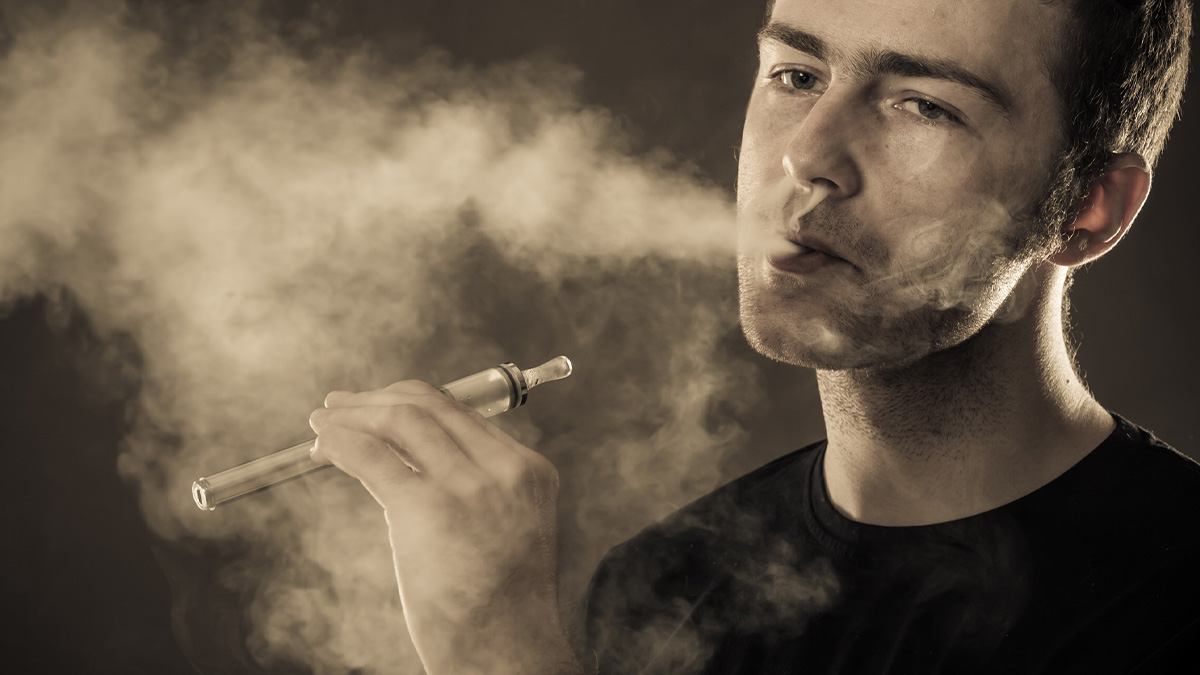 Man in blackshirt smoking a dank vape