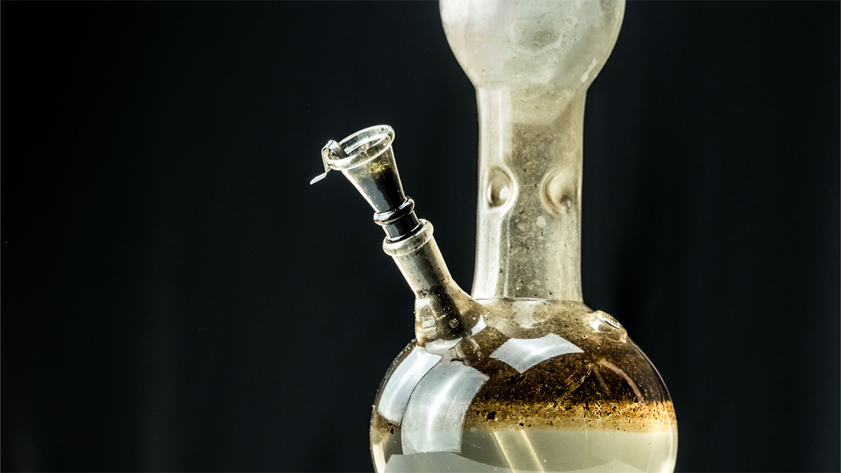 Dirty marijuana bong in black background how to clean it