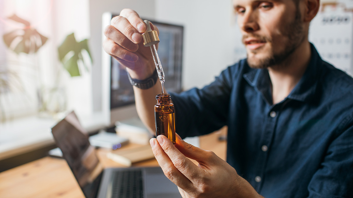 A man about to take a dose of CBD oil