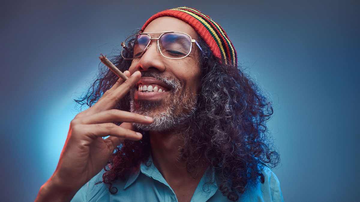Rastafarian man thinking while high on weed smoking