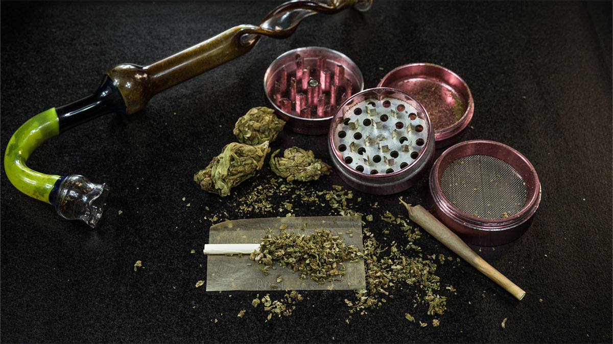 Weed grinder and marijuana buds and bong