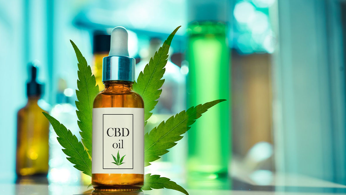 CBD oil bottle and marijuana leaf.